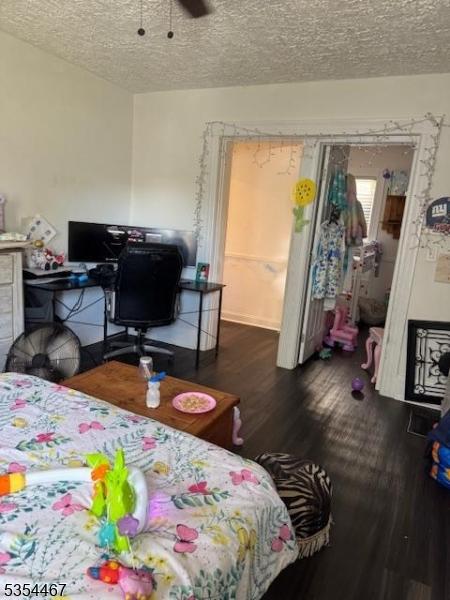 252 Spring St, Newton Town, NJ 07860 - bedroom with wood finished floors, a textured ceiling, a desk, and a ceiling fan