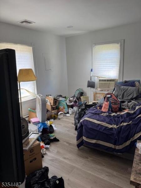 252 Spring St, Newton Town, NJ 07860 - bedroom with wood finished floors, multiple windows, and cooling unit