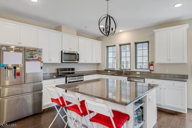 kitchen featuring open shelves, recessed lighting, white cabinetry, a sink, and stainless steel appliances