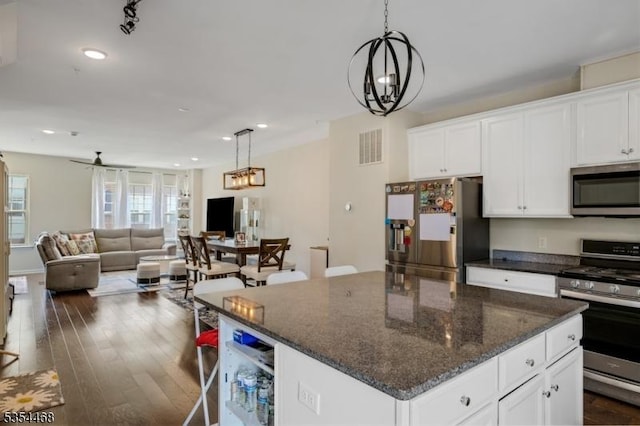 kitchen with wine cooler, white cabinets, and stainless steel appliances