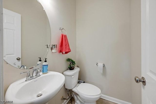 bathroom with a sink, tile patterned floors, and toilet