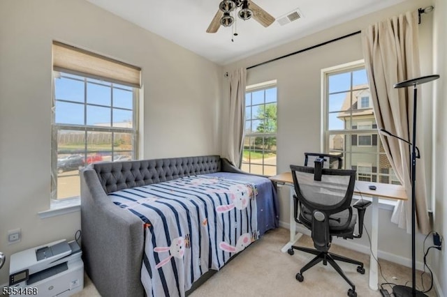 bedroom featuring visible vents, baseboards, and light carpet