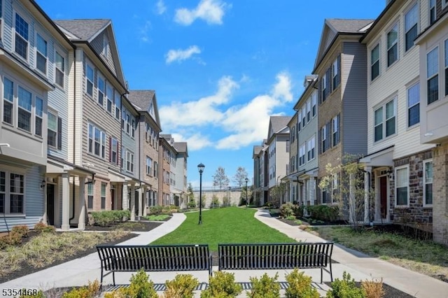 view of property's community featuring a yard and a residential view