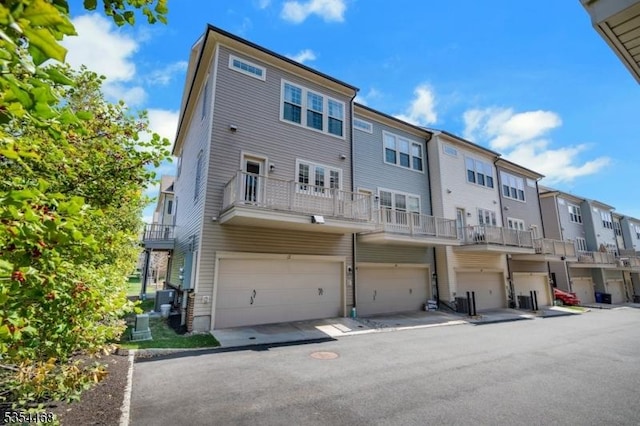 back of property featuring a garage and a residential view