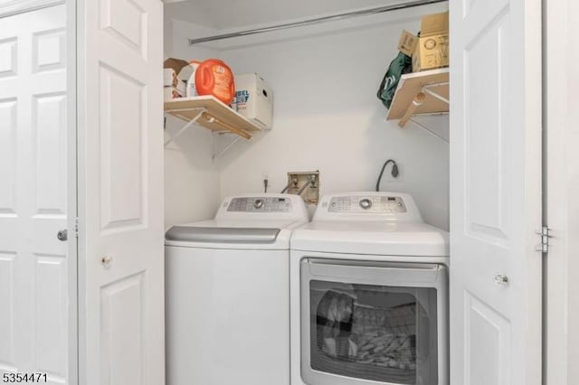 washroom featuring washer and dryer and laundry area