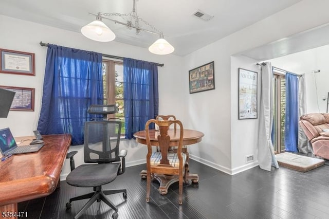 dining room with visible vents, baseboards, and wood finished floors