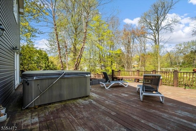 wooden deck with a hot tub