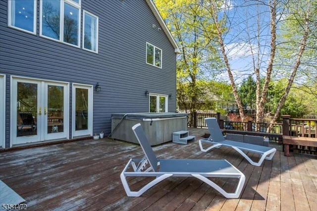deck with a hot tub and french doors