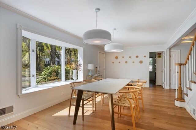 dining area featuring visible vents, stairs, crown molding, and a healthy amount of sunlight
