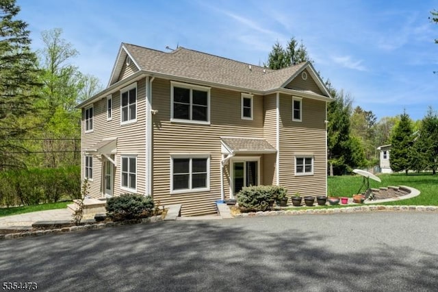 view of front of house with roof with shingles