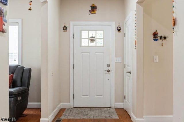 entrance foyer featuring baseboards and wood finished floors