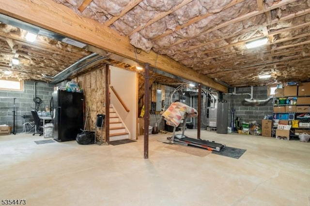 basement with heating unit, freestanding refrigerator, stairs, and electric panel