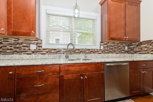 kitchen featuring backsplash, light stone countertops, a sink, and dishwasher