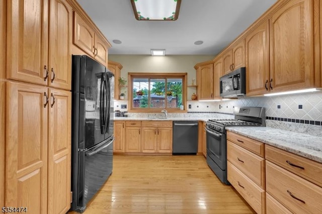 8 Katherine St, Denville Twp, NJ 07834 - kitchen featuring stainless steel appliances, light wood-type flooring, backsplash, light stone countertops, and light brown cabinetry