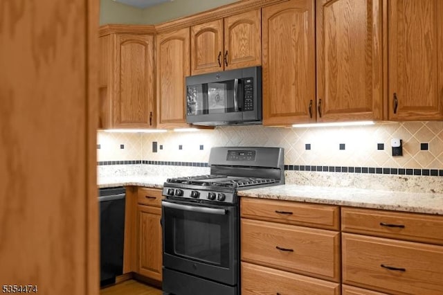 8 Katherine St, Denville Twp, NJ 07834 - kitchen with black appliances, light stone counters, and backsplash