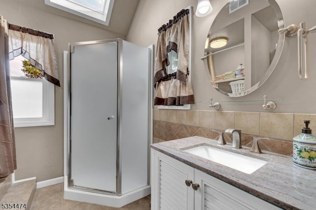 8 Katherine St, Denville Twp, NJ 07834 - bathroom featuring a skylight, vanity, a stall shower, and tile patterned floors