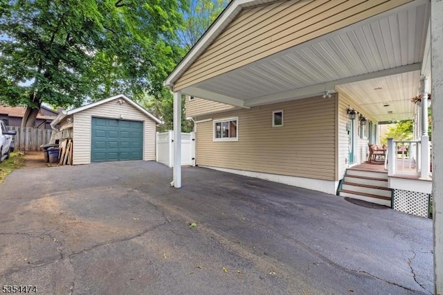 8 Katherine St, Denville Twp, NJ 07834 - view of property exterior featuring asphalt driveway, a detached garage, an outbuilding, a porch, and a carport