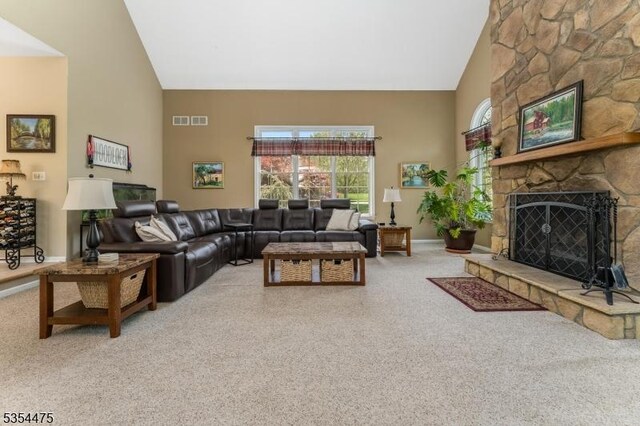 11 Southgate Dr, Clinton Twp, NJ 08801 - carpeted living room featuring baseboards, visible vents, a fireplace, and high vaulted ceiling