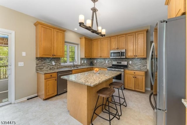 11 Southgate Dr, Clinton Twp, NJ 08801 - kitchen featuring appliances with stainless steel finishes, a center island, tasteful backsplash, and a sink