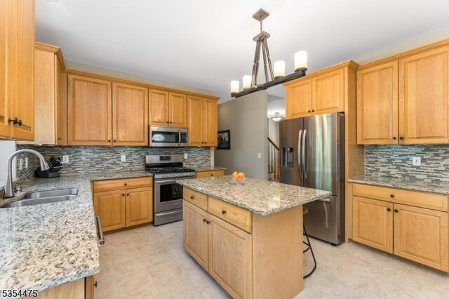 11 Southgate Dr, Clinton Twp, NJ 08801 - kitchen with a center island, a sink, light stone countertops, appliances with stainless steel finishes, and decorative backsplash