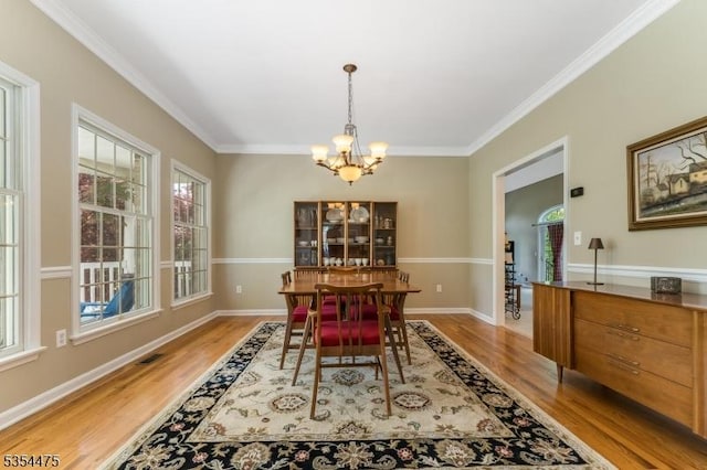 11 Southgate Dr, Clinton Twp, NJ 08801 - dining space featuring wood finished floors, a notable chandelier, visible vents, baseboards, and ornamental molding