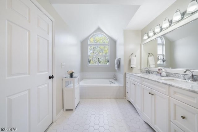 full bathroom with a sink, a bath, double vanity, and lofted ceiling