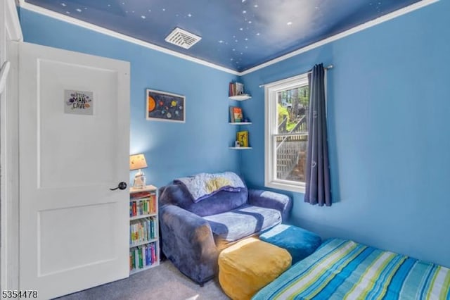 sitting room with visible vents, carpet flooring, and crown molding
