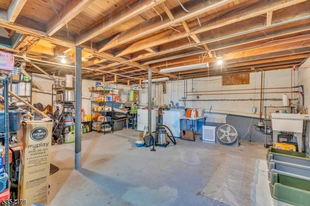 unfinished below grade area with a sink and a workshop area