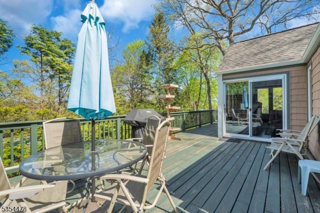 wooden terrace with outdoor dining area