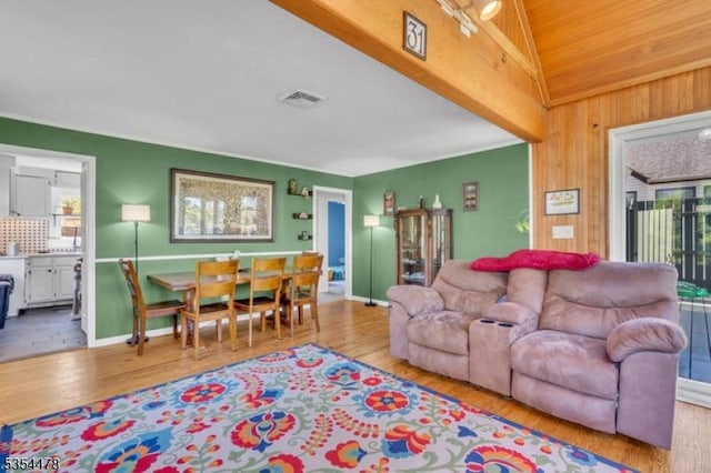 living area featuring visible vents, a wealth of natural light, and wood finished floors