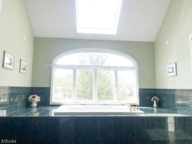 kitchen featuring lofted ceiling with skylight