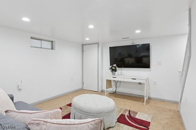 living area with recessed lighting and baseboards