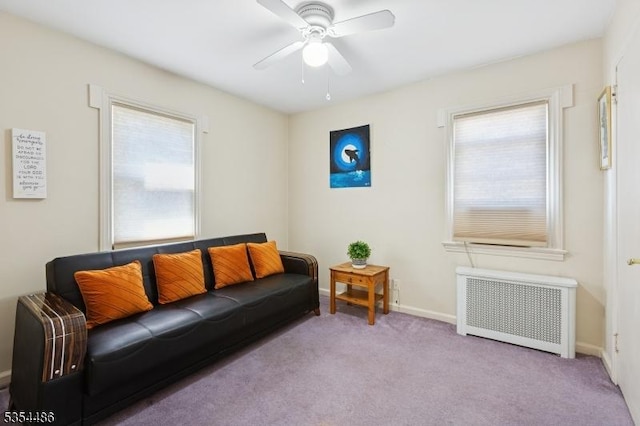 living room with plenty of natural light, a ceiling fan, radiator, and carpet floors