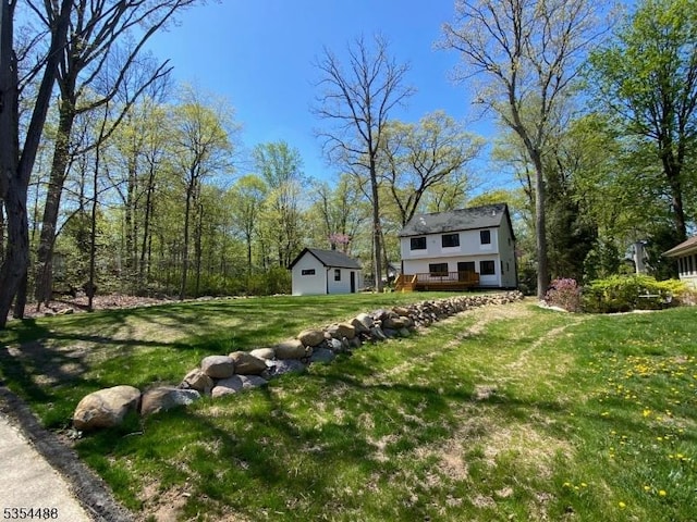 view of yard with a deck and an outdoor structure