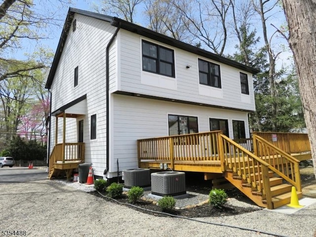 back of house featuring central AC and a deck