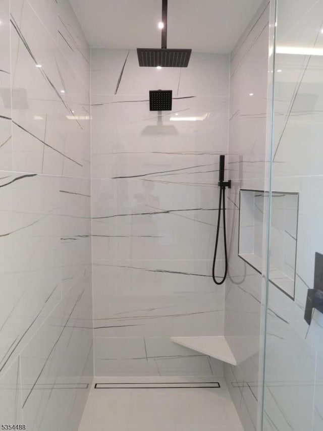 full bathroom featuring a marble finish shower