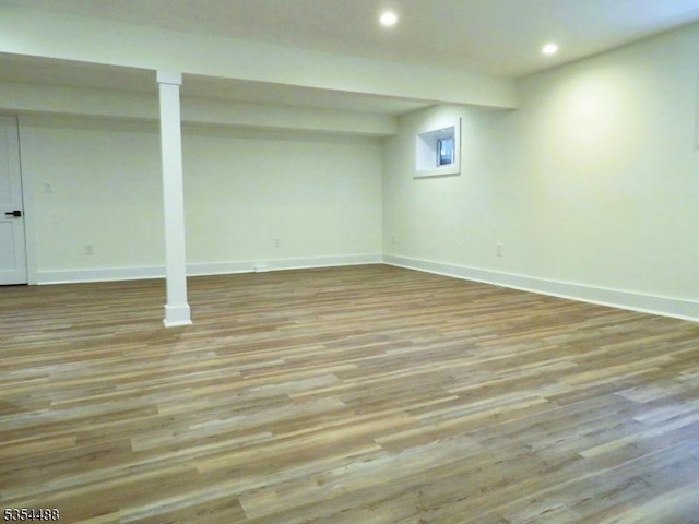 finished basement with recessed lighting, baseboards, and wood finished floors