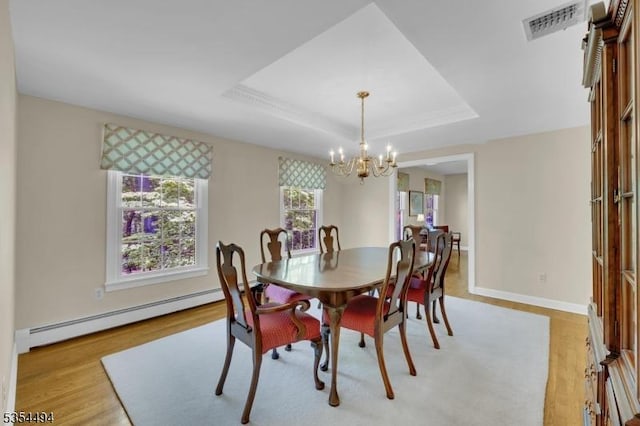 21 Dorset Rd, Washington Twp, NJ 07853 - dining area with a baseboard radiator, a chandelier, light wood-type flooring, and a tray ceiling