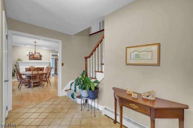 21 Dorset Rd, Washington Twp, NJ 07853 - foyer entrance featuring a chandelier, stairway, a baseboard heating unit, baseboards, and light wood-style floors