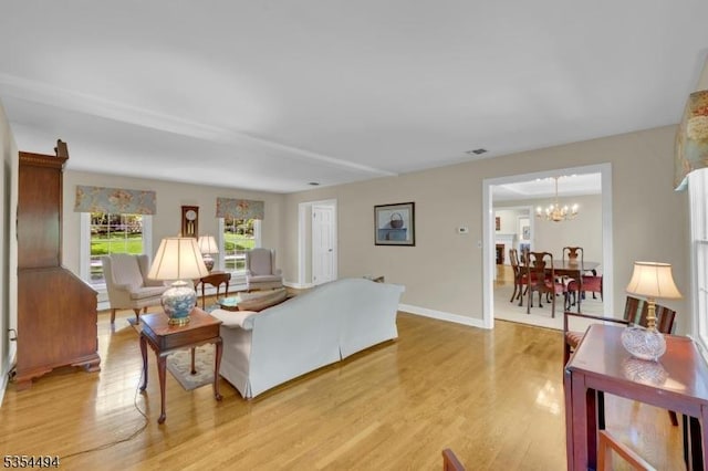 21 Dorset Rd, Washington Twp, NJ 07853 - living room with light wood-style floors, a chandelier, and baseboards