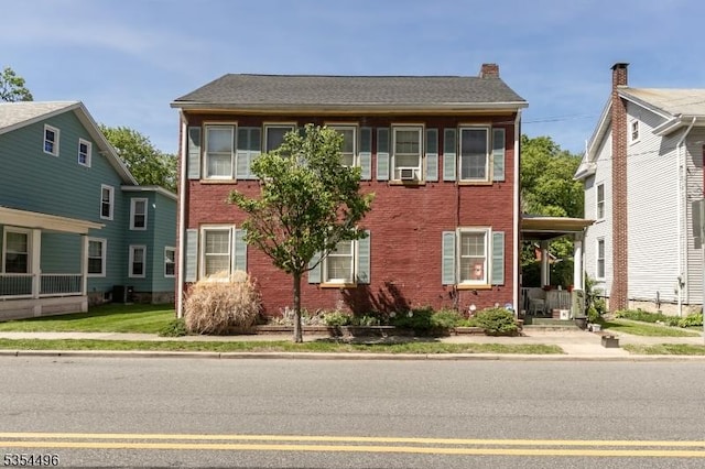 colonial home featuring brick siding