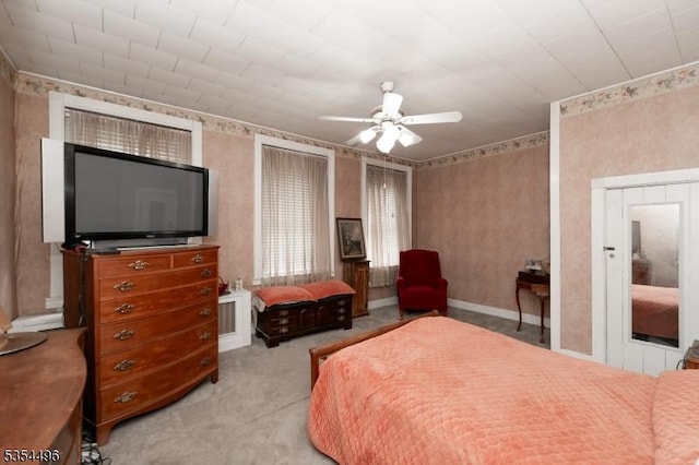 carpeted bedroom with a ceiling fan