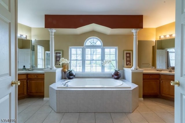 full bath with a garden tub, a sink, decorative columns, and tile patterned floors