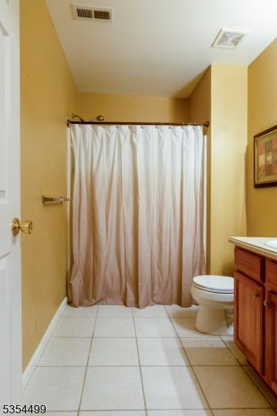full bathroom with visible vents, tile patterned flooring, toilet, and vanity