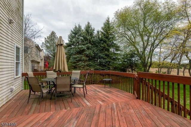 wooden terrace with outdoor dining area