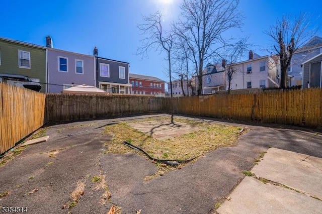 view of yard with a residential view and a fenced backyard