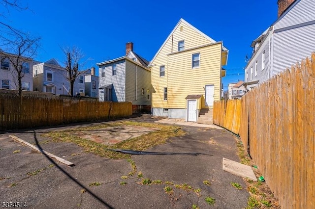 back of property featuring fence and a residential view