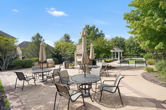 26 Avon Rd, Warren Twp, NJ 07059 - view of patio featuring outdoor dining space, exterior fireplace, and area for grilling