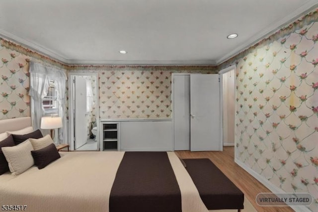 bedroom with ornamental molding, light wood finished floors, and wallpapered walls