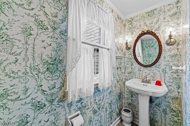 bathroom featuring crown molding and wallpapered walls
